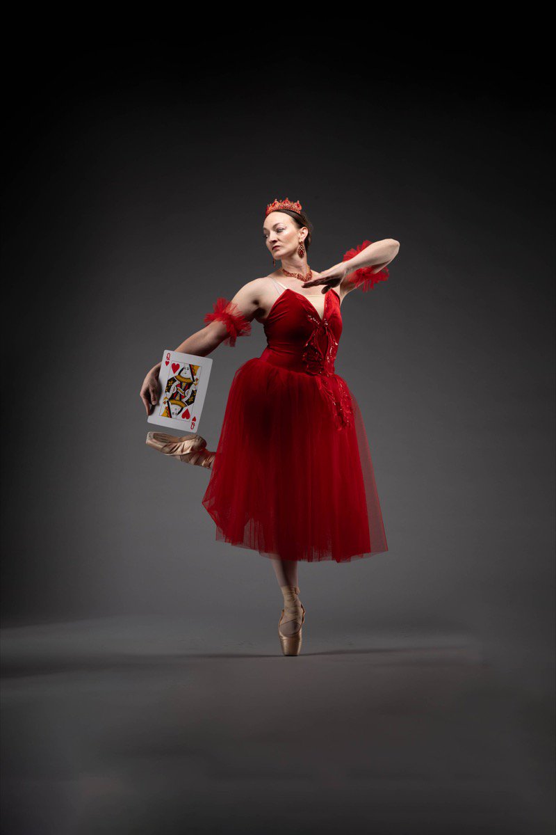 Ballet dancer performing as the Queen of Hearts in red costume